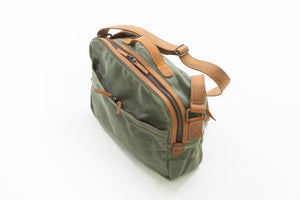 William Ross weatherproof travel bag has two back pockets that have hidden zippers to hold your passport while waiting in line at the airport. No more holding your passport for two hours while carrying a back pack on your back.